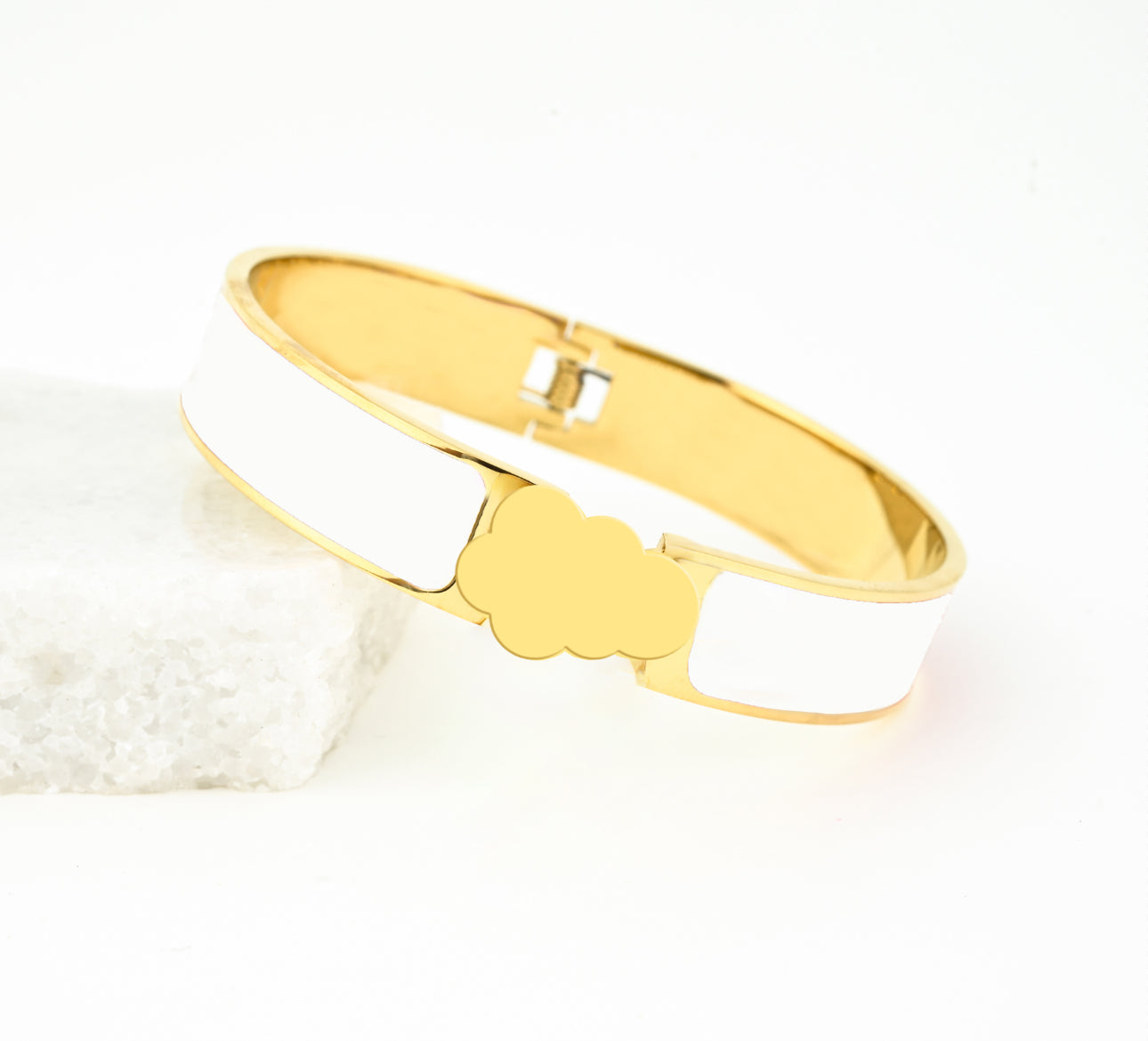 White bracelets with the a gold cloud closure