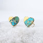 Heart-shaped earrings with turquoise and gold finish on a white background