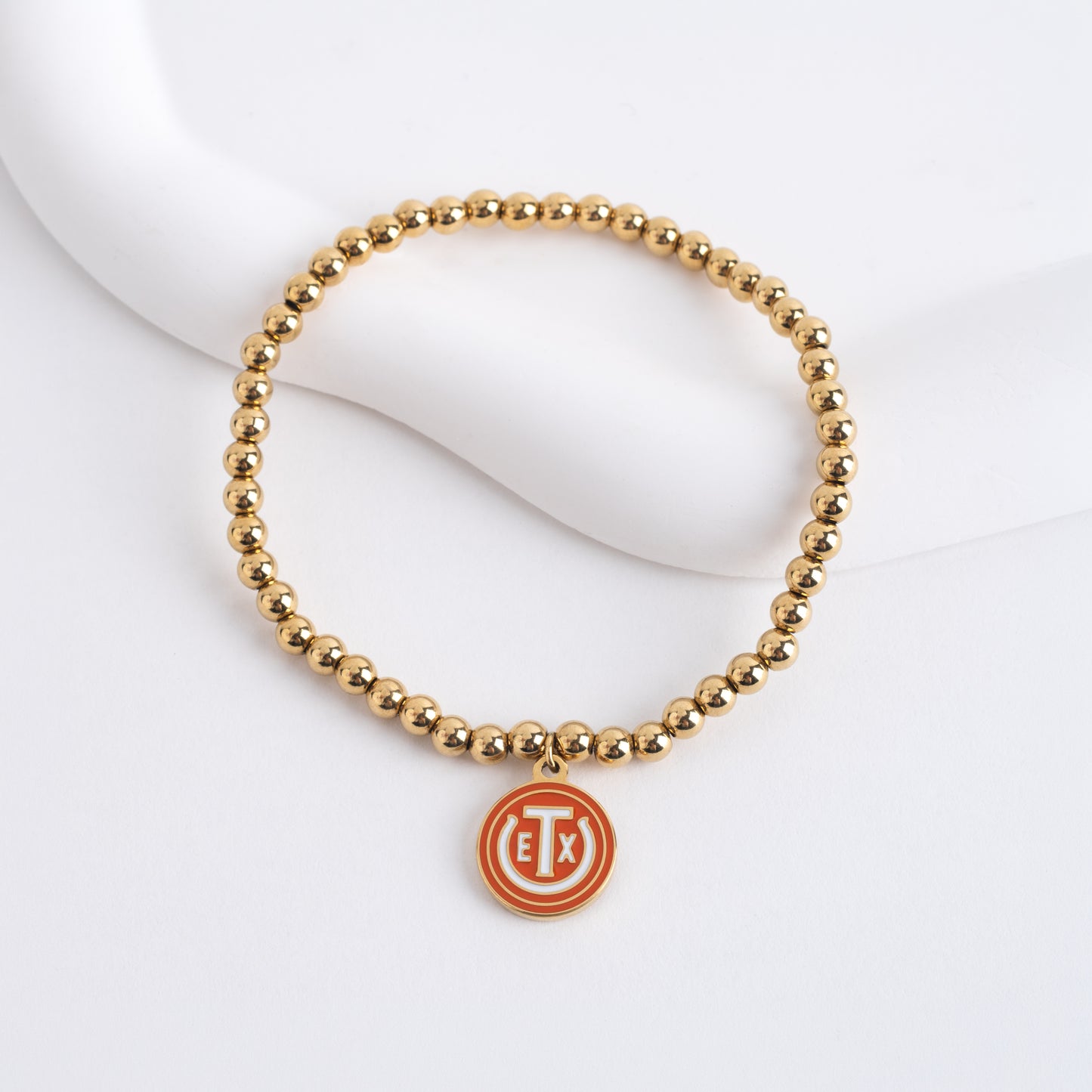 4mm Bead Bracelet with 0.5" burnt orange logo tag