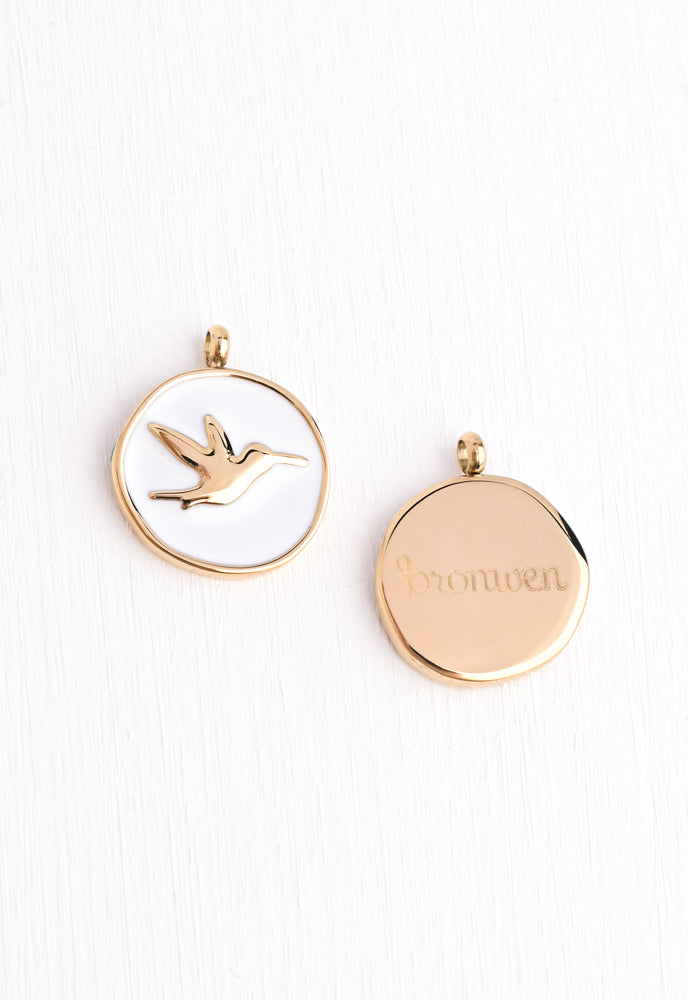 White enamel pendant with a  hummingbird pendant
