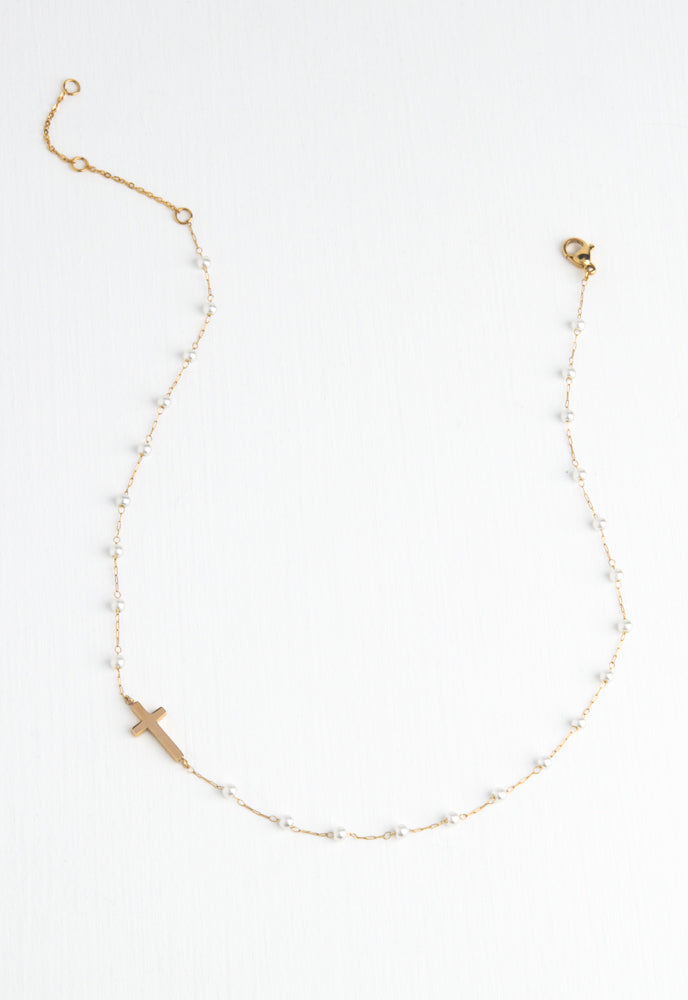 Floating cross, o-centered on chain with loosely spaced pearls necklace
