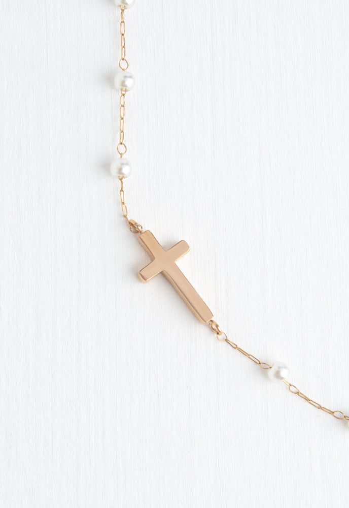 Floating cross, o-centered on chain with loosely spaced pearls necklace